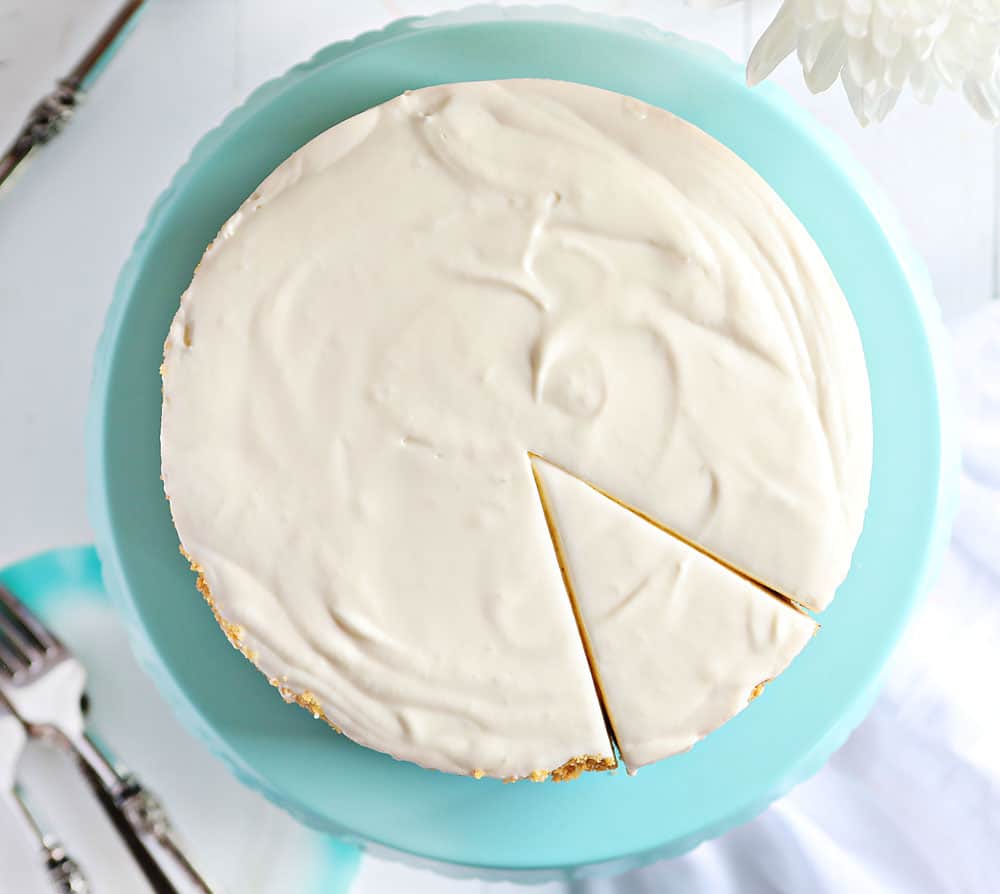 The best no-bake desserts to get your sweet tooth through the summer! no bake, no bake desserts, desserts, recipes, cheesecake, cookies, bars, cake, pudding, mousse, puppy chow, muddie buddies, rice krispy bars, dessert, memorial day dessert, labor day desserts, i am baker, iambaker No Bake Cheesecake From Overhead with One Piece Cut.